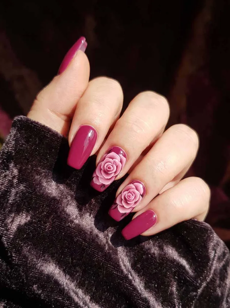Coffin-shaped deep magenta berry nails with a fully shaded layered pink rose painted in blush rose and white on the accent nails