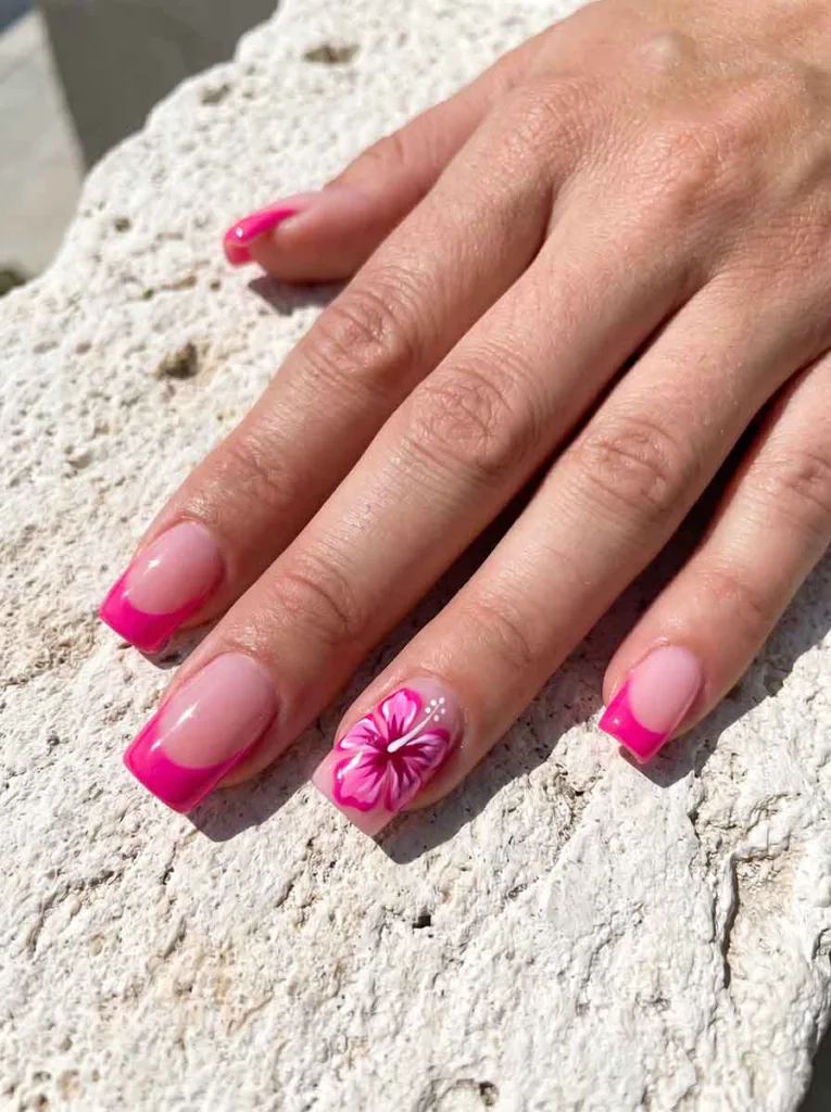 Square hot pink French tip nails with a bold hand-painted hibiscus bloom in magenta and pink on the accent nail