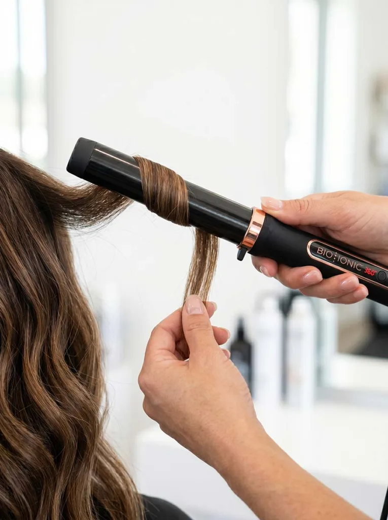 Step-by-step curling wand technique for beach waves — wrapping hair away from face