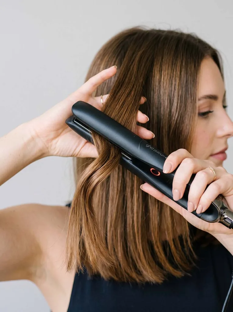 Flat iron technique for creating soft beach waves — rotating iron away from face