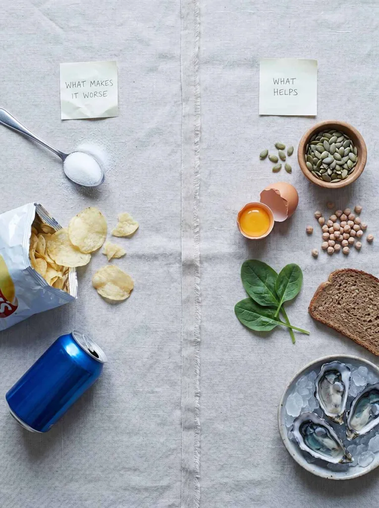 Split flat lay showing sugar-heavy processed foods and a stress journal on one side and zinc-rich whole foods like pumpkin seeds and leafy greens on the other