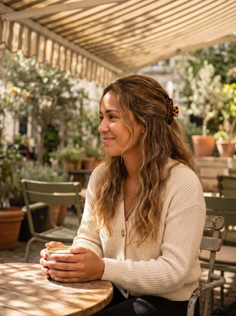 loose half-up twist hairstyle on long wavy hair — casual outdoor portrait