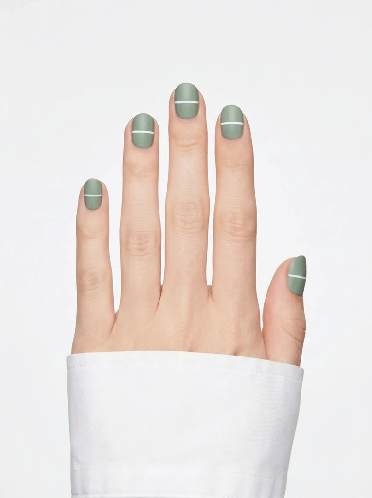 Horizontal white stripe nail art on short round nails, fair skin, sage green base — clean front-facing studio shot