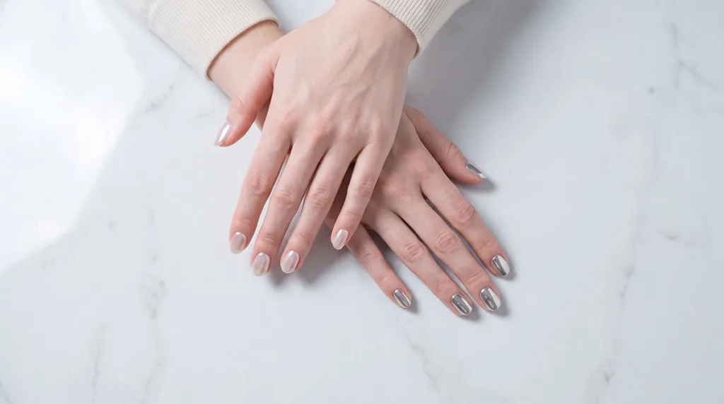 innovative almond shaped nail designs 2026 featuring glazed donut shimmer, chrome, and burgundy velvet on fair skin