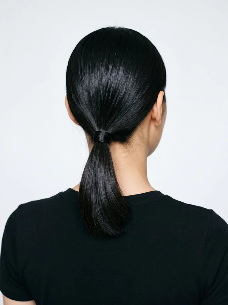 mini ponytail on short hair — neat low ponytail at the nape with wrapped elastic