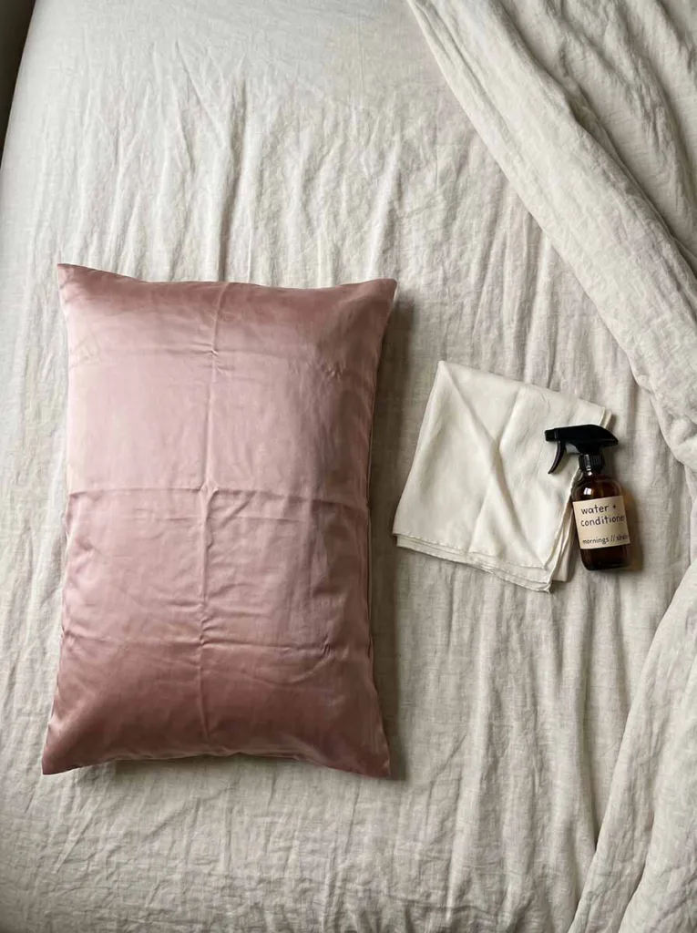 satin pillowcase and silk hair scarf laid out on bed for overnight heatless curl protection