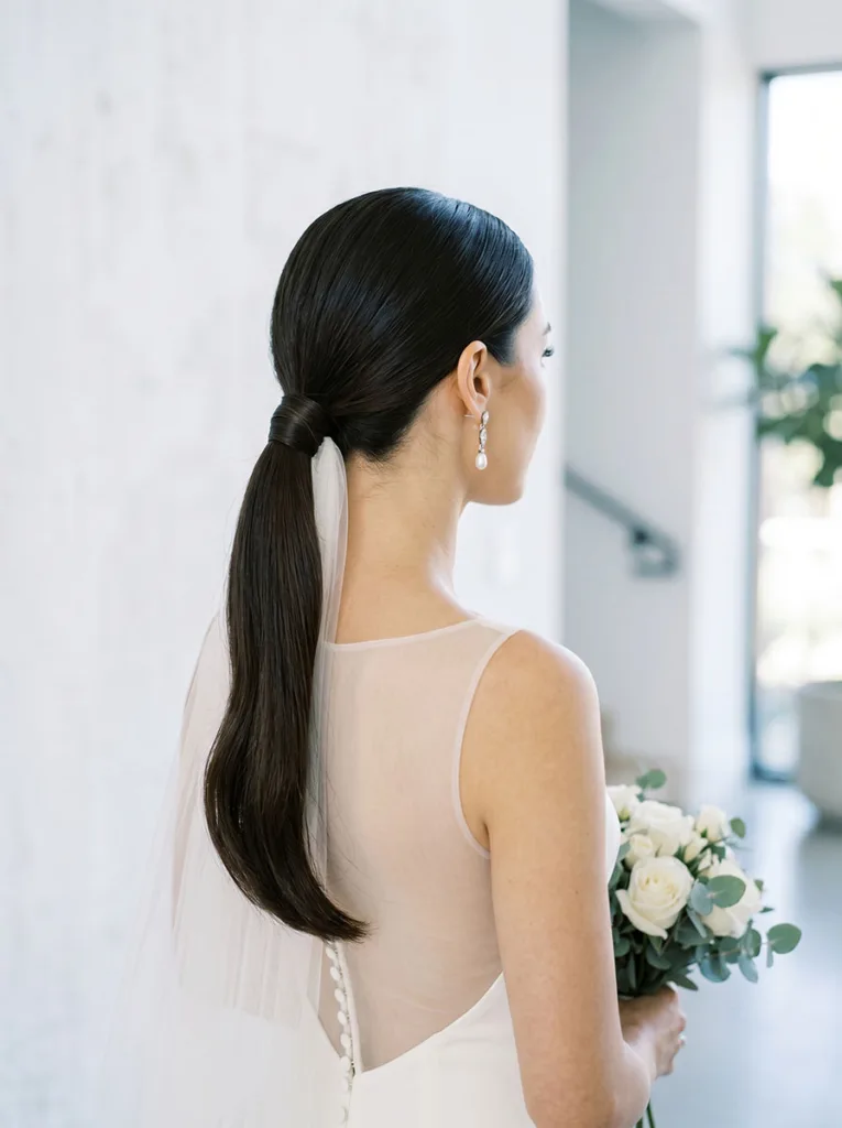 Modern minimalist bridal sleek low ponytail hairstyle wedding 2026