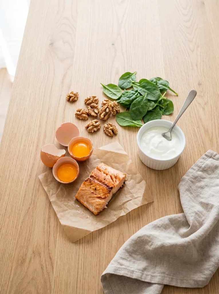flat lay of hair-healthy foods including eggs salmon nuts and leafy greens for stronger hair growth