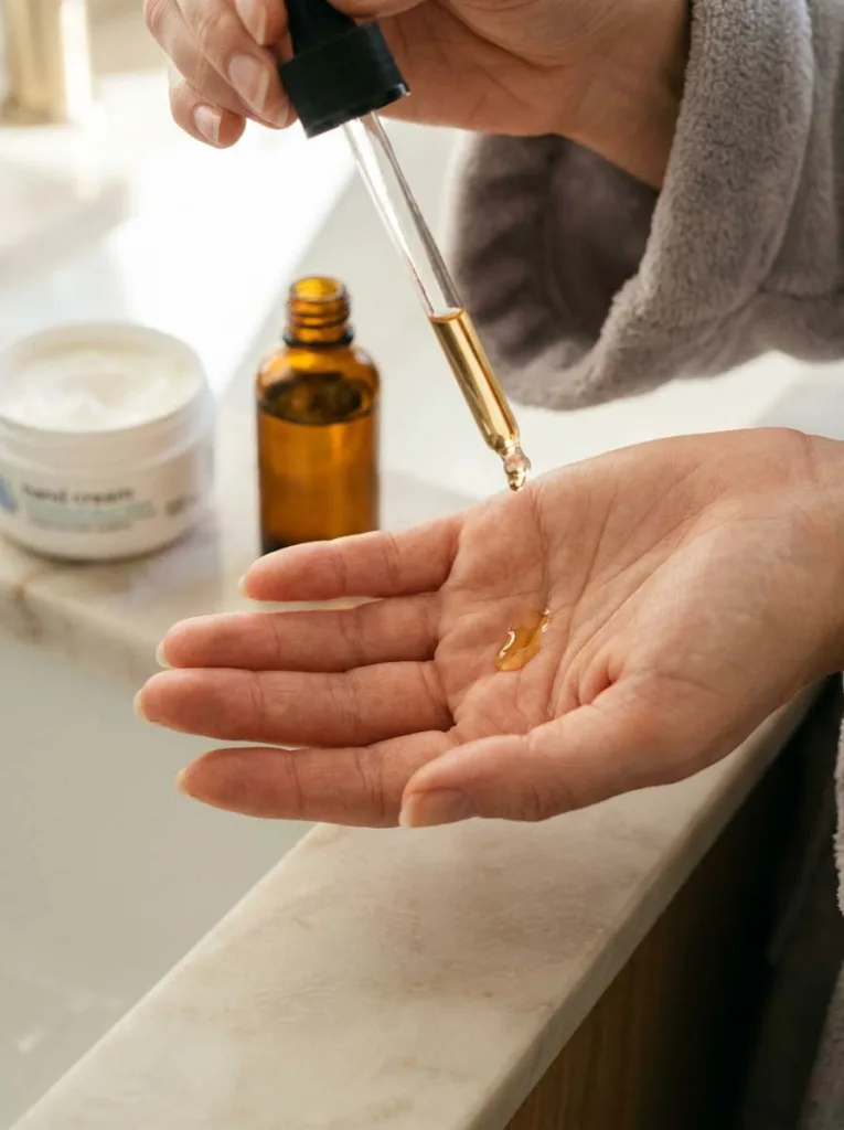 Applying cuticle oil to protect winter nails from cracking and dryness