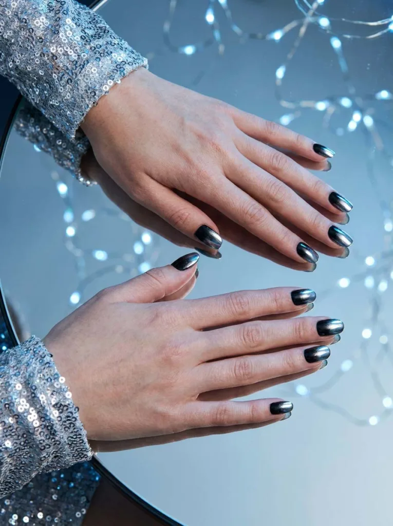 Black and silver chrome ombre Christmas nails reflecting party lights