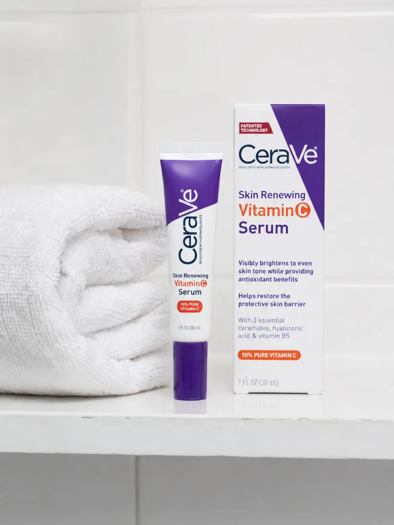 CeraVe Vitamin C Serum bottle on a bathroom shelf with towel