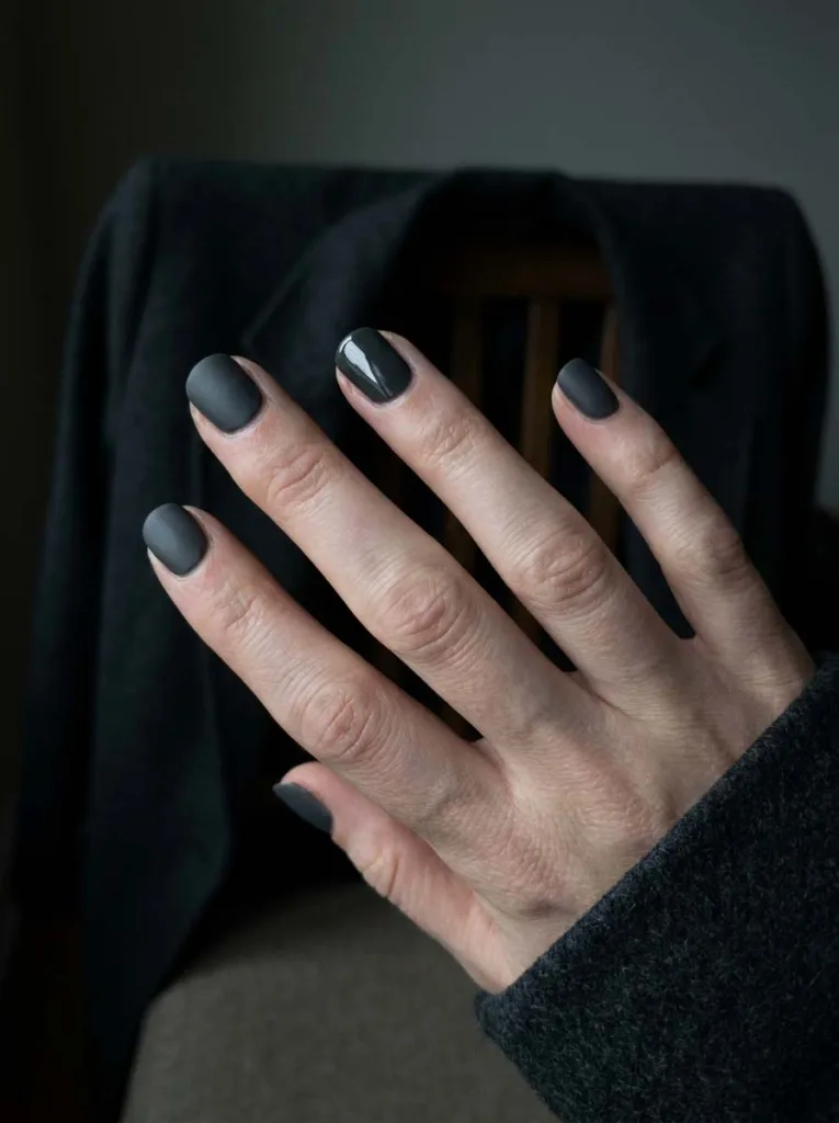 Charcoal gray matte winter nails with one glossy accent finger
