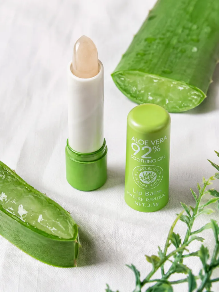 Nature Republic Aloe Vera soothing lip balm next to a fresh aloe leaf