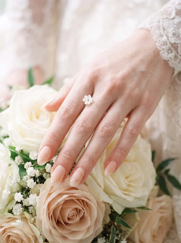 Peach wedding nails with lace and bridal bouquet detail