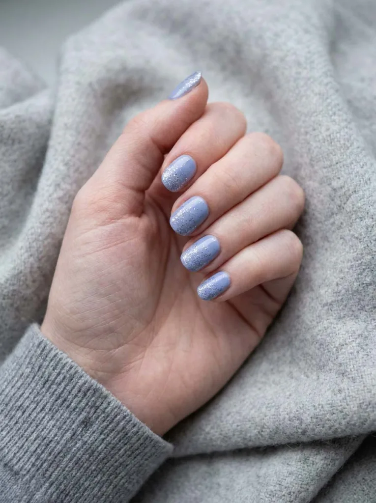 Periwinkle winter nails with silver glitter tip dusting