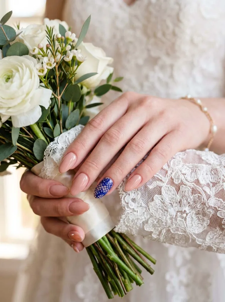 hand with royal blue bridal lace nails holding a wedding bouquet