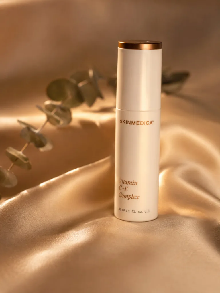 SkinMedica Vitamin C+E Complex serum bottle on gold silk fabric
