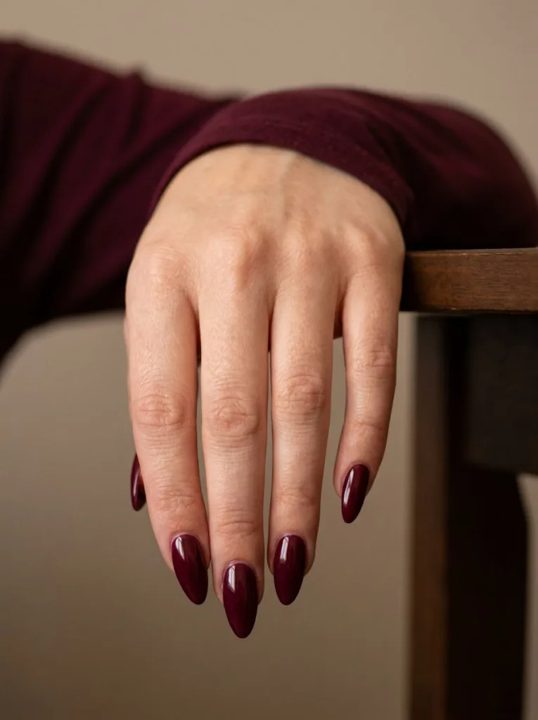 Close-up of glossy wine red Thanksgiving nails