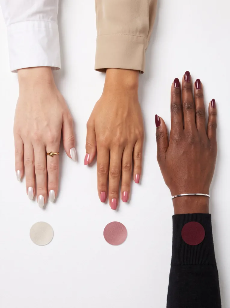 Three Hands Showing Nail Color Recommendations for Fair Medium and Deep Skin Tones