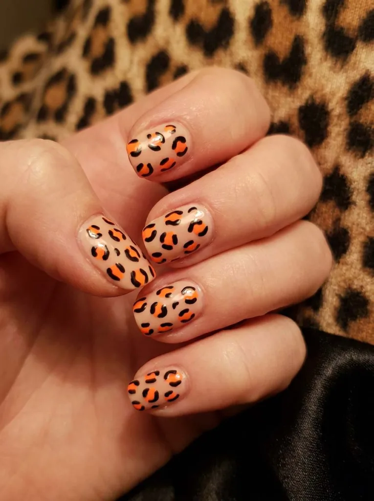 Neon animal print nail design with leopard spots on a nude base