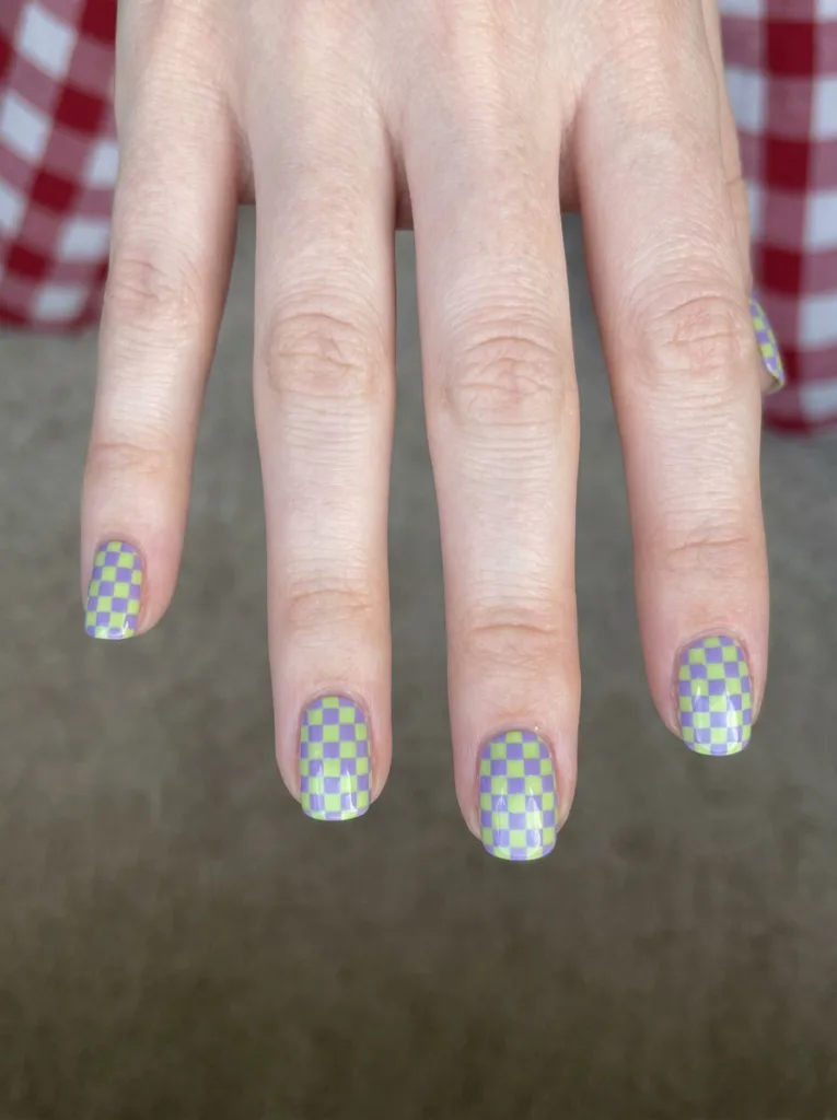 Neon checkerboard nail design in lime and lavender