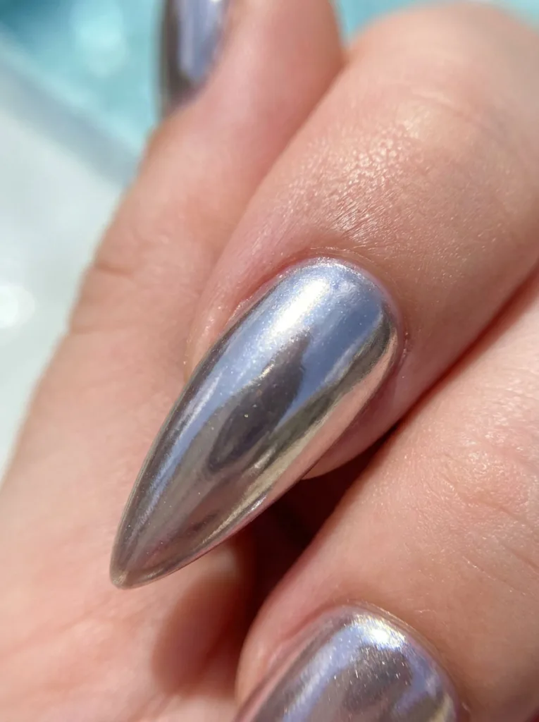 Neon chrome tip nail design reflecting sunlight by the pool