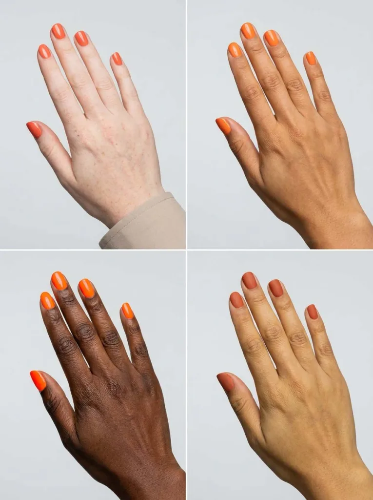 Four hands of different skin tones wearing coral, tangerine, neon, and terracotta orange nail polish