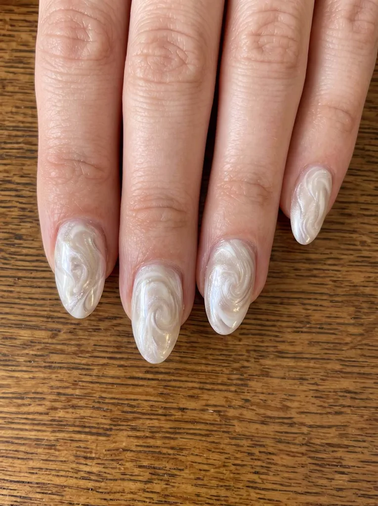 close-up of pearl swirl wedding nail art at a bridal vanity