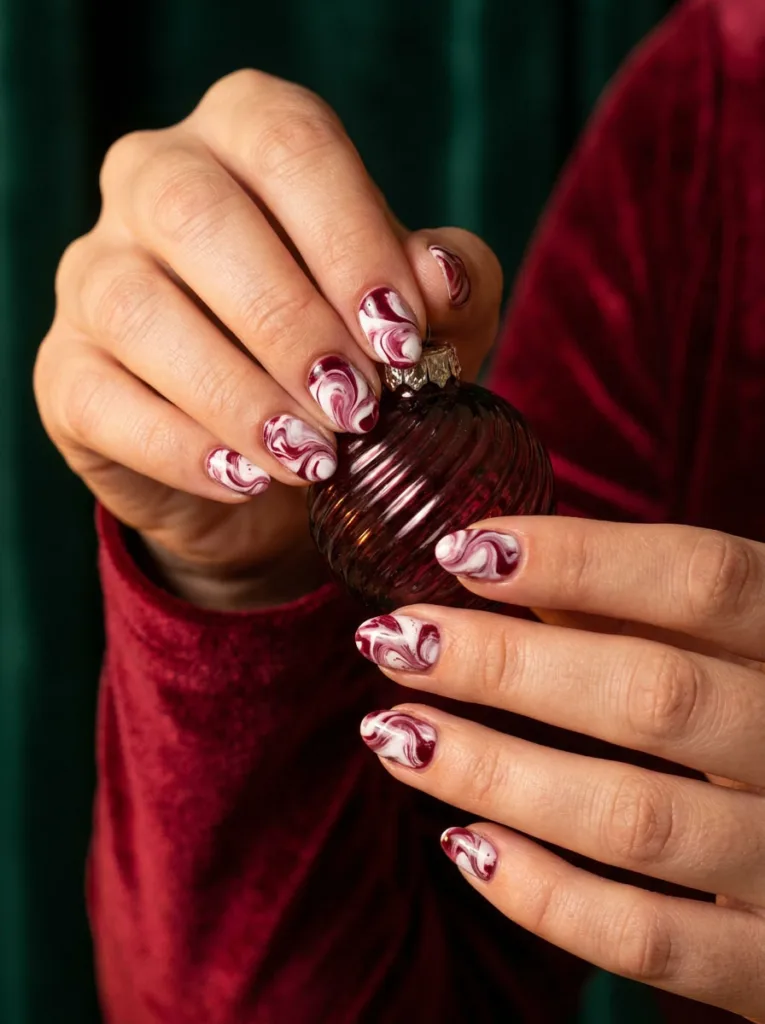 White and burgundy swirl nail art design