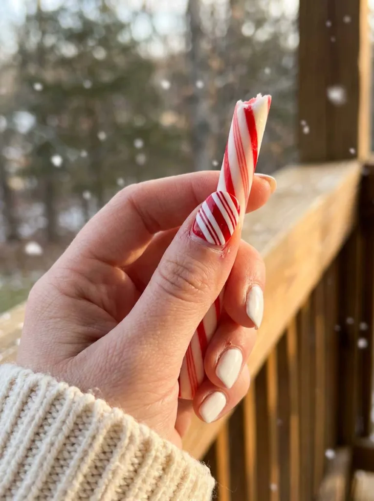 White nails with a candy cane stripe accent nail