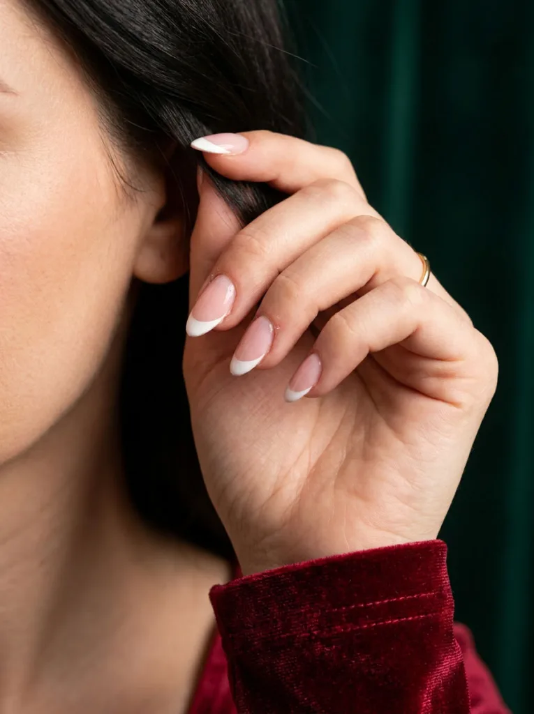 Classic white French tip nails on an almond nail shape