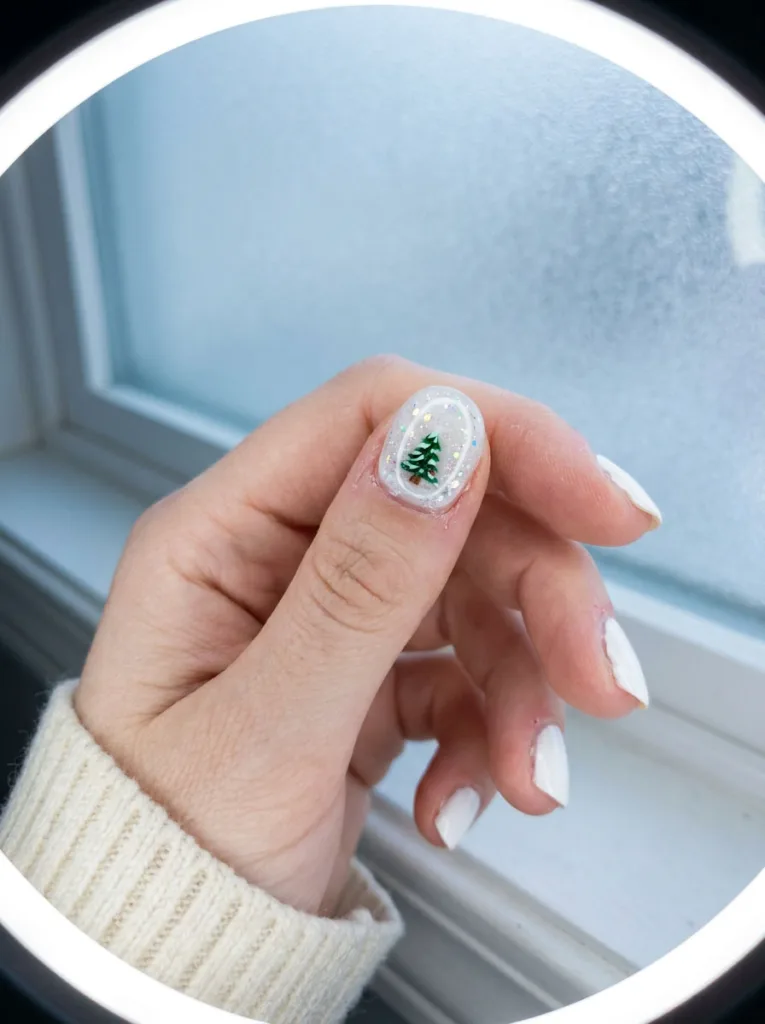 Snow globe accent nail design with glitter and clear gel