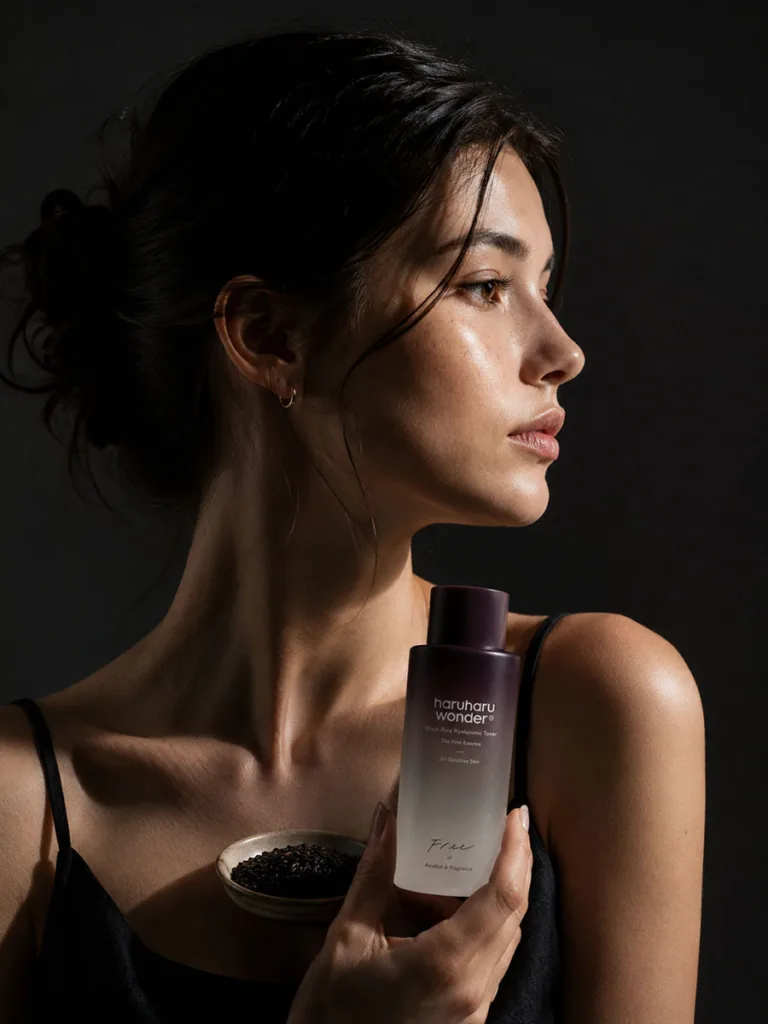 Moody side-lit portrait representing Haruharu Wonder black rice toner's antioxidant depth
