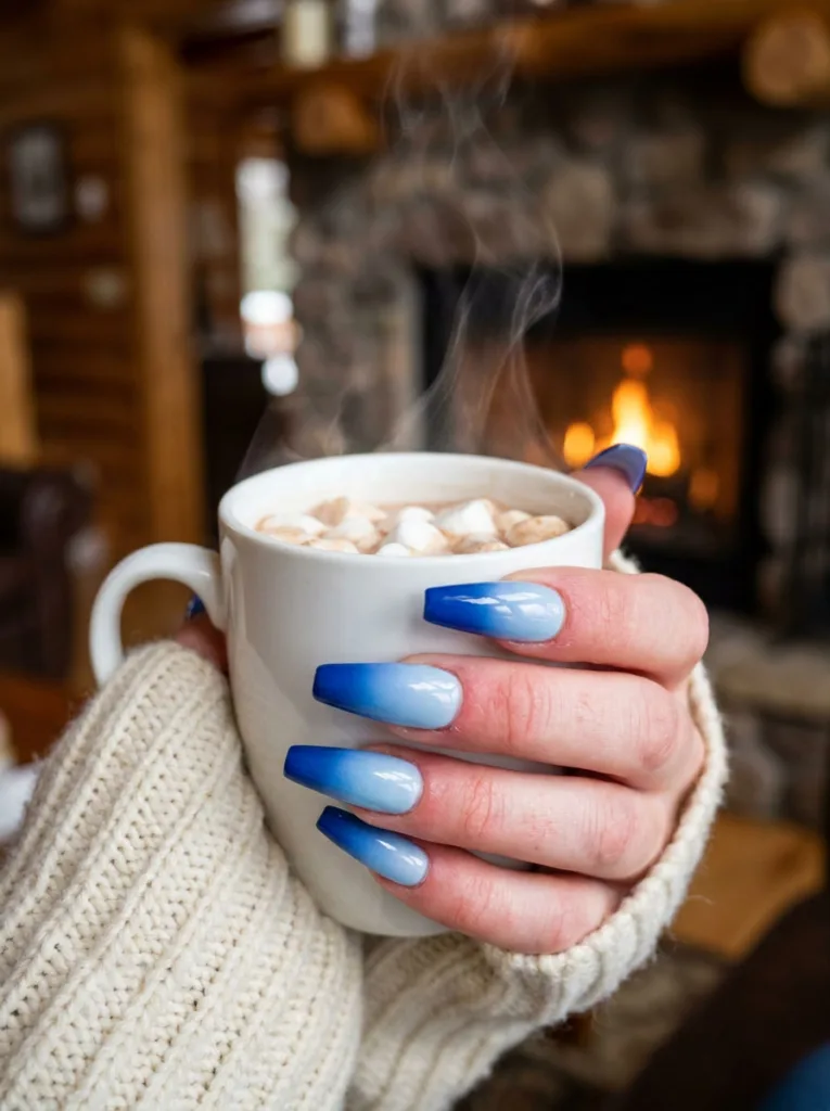 Blue ombre winter nails fading from cobalt to sky blue