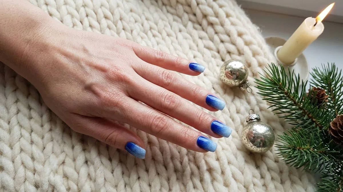 Blue winter nails featured image showing an icy navy ombre manicure