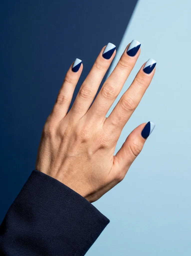 Two-tone diagonal blue winter nails in navy and pastel