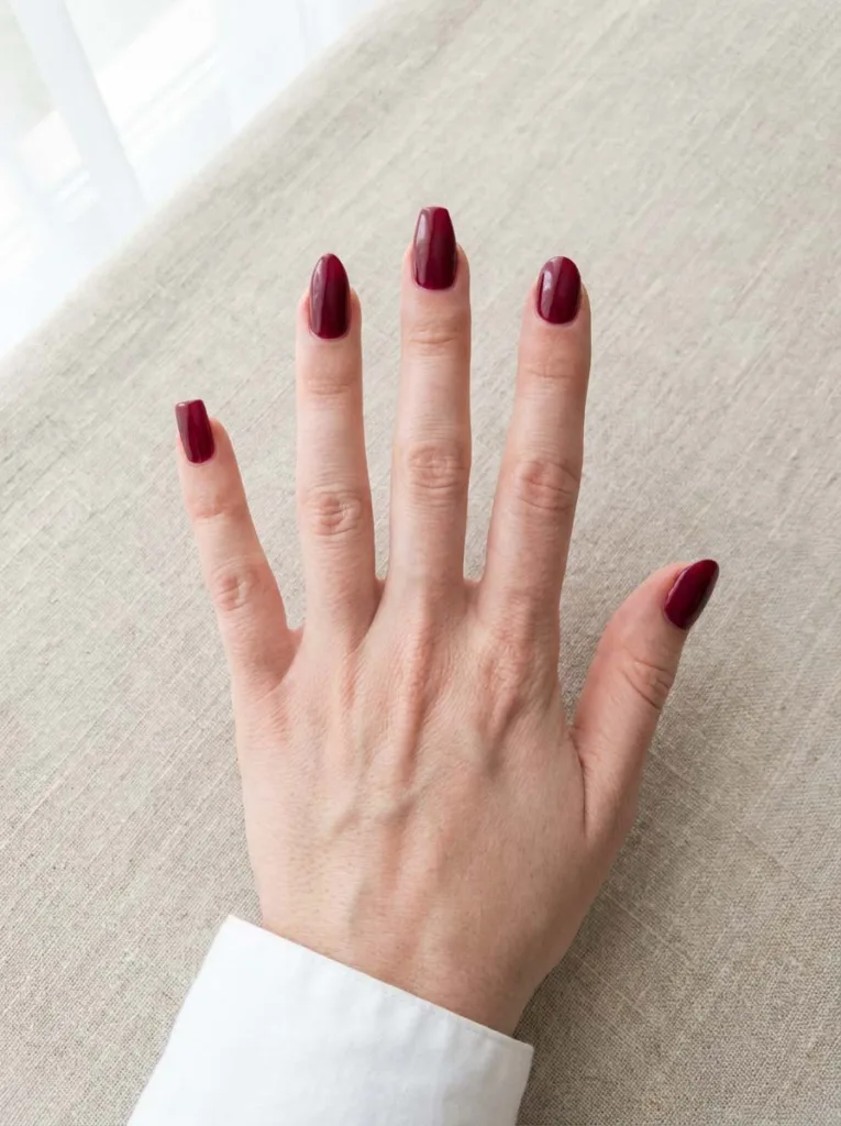 Burgundy nail polish shown on square, almond, coffin, and round nail shapes