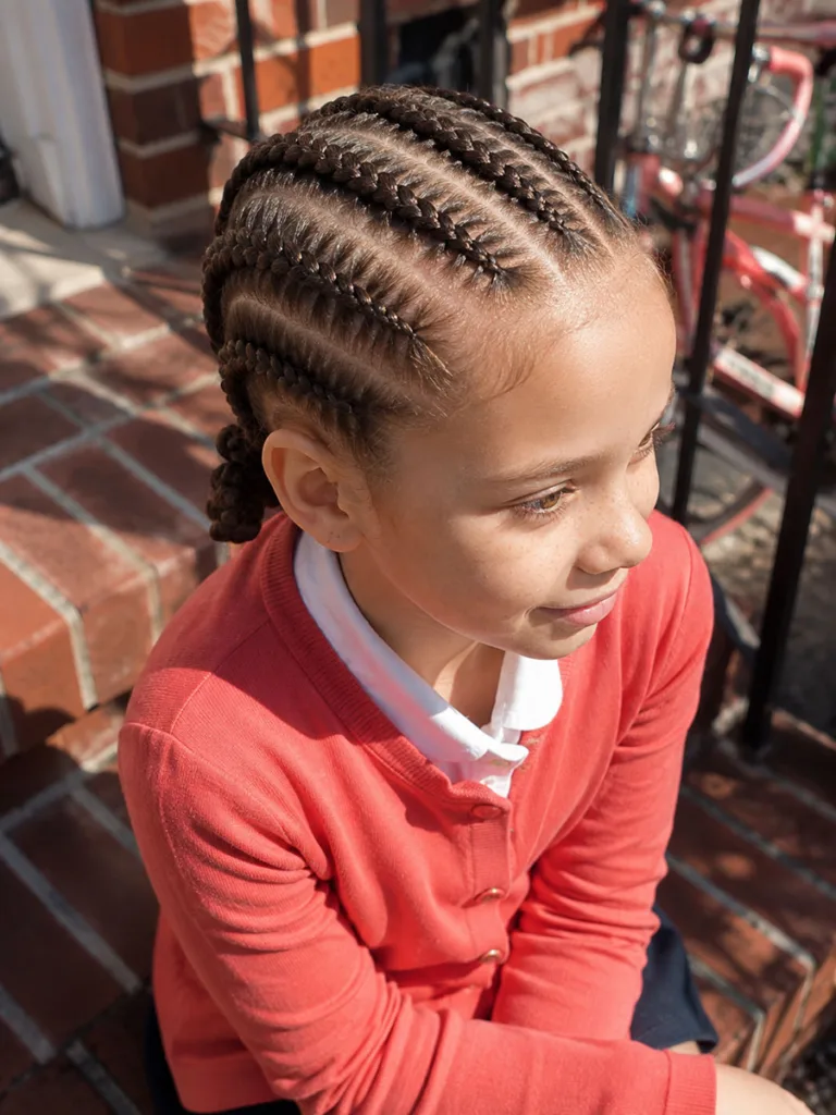 Neat cornrows hairstyle for school shown on a young girl