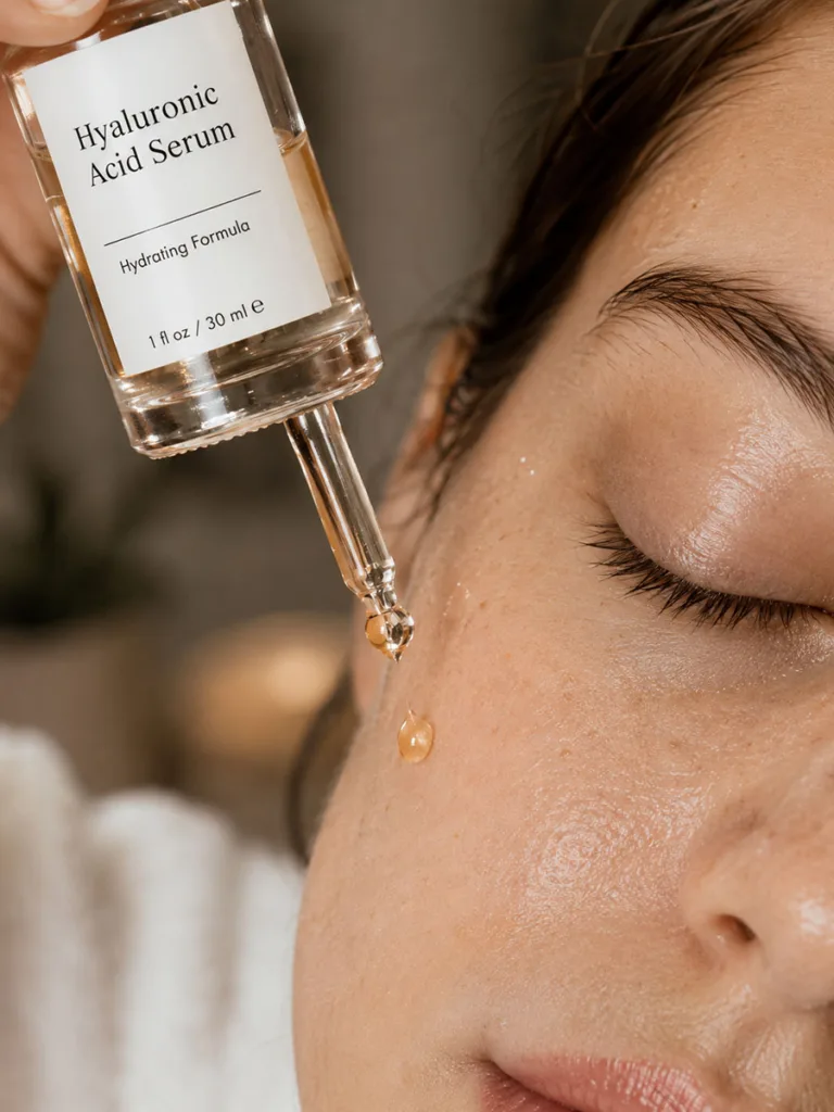 Hyaluronic acid serum droplet applied to damp skin for fall hydration