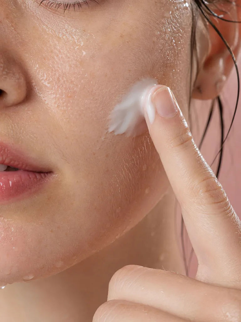 Close-up of moisturizer being applied to damp skin for better hydration