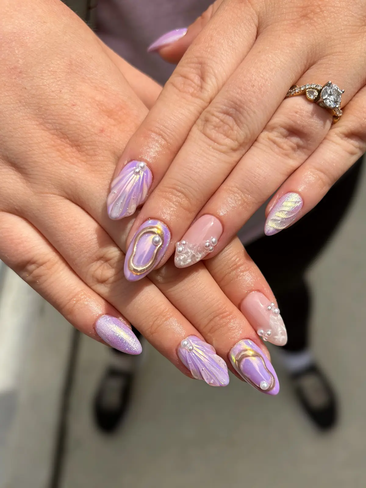 Lavender and pink nails with raised shell ridges, pearls and gold outlines