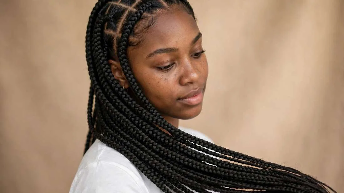 Classic long box braids hairstyles on a young woman with neat square parts