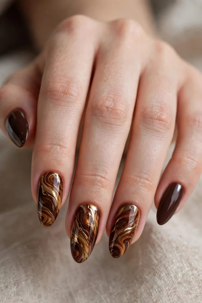 Marbled brown and gold swirl nail art